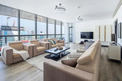 a living room with couches and a tv at Frank Porter - 23 Marina in Dubai