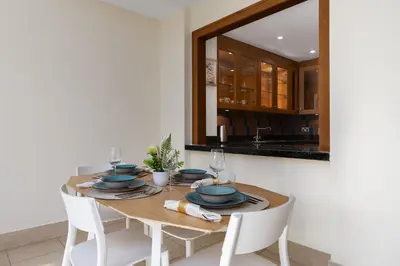 a dining room with a table with chairs and a mirror at Maison Privee - Stylish & Spacious Apartment in Downtown Dubai in Dubai