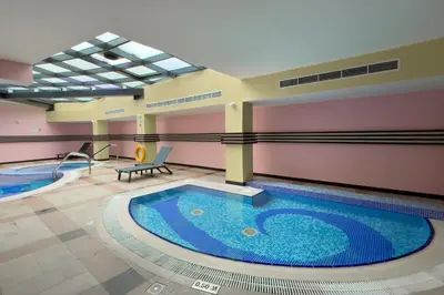 a large swimming pool in a building with a swimming pool at GuestReady - Serene Dubai Marina haven in Dubai