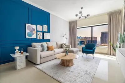 a living room with a couch and a table at GuestReady - Serene Dubai Marina haven in Dubai
