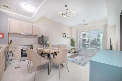 a kitchen and dining room with a table and chairs at Elegant 1BR with Balcony & Views in Business Bay in Dubai