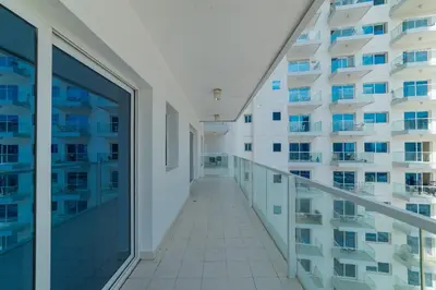 a corridor of an apartment building with glass windows at Luxurious 1-BR with Balcony & Views Business Bay in Dubai