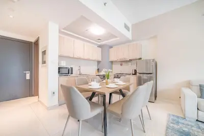 a kitchen and dining room with a table and chairs at Luxurious 1-BR with Balcony & Views Business Bay in Dubai