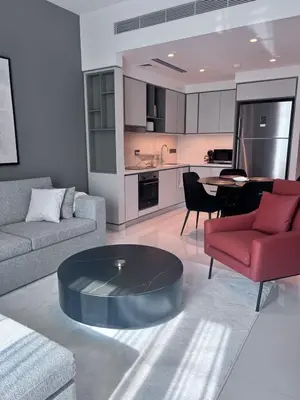 a living room with a couch and a coffee table at A Luxurious 2 Bedroom Emaar Beachfront Apartment in Palm Jumeirah in Dubai