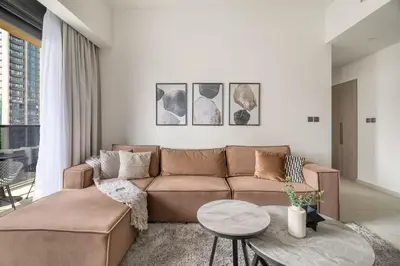 a living room with a brown couch and a table at GuestReady - Charming retreat in Downtown Dubai in Dubai