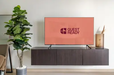a tv on a cabinet in a living room with a plant at GuestReady - Charming retreat in Downtown Dubai in Dubai