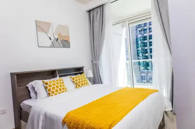 a bedroom with a large bed and a window at Cozy 1BR Apartment with Water View Business Bay in Dubai