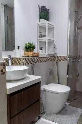 a bathroom with a toilet and a sink and a shower at Cozy 1BR Apartment with Water View Business Bay in Dubai