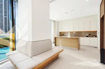 a living room with a white couch and a kitchen at FIRST CLASS 1BR Stylish & Luxurious in Dubai
