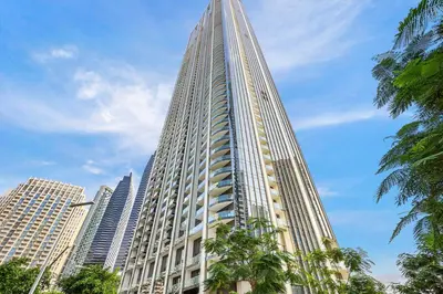 a tall building with palm trees in front at FIRST CLASS 1BR Stylish & Luxurious in Dubai