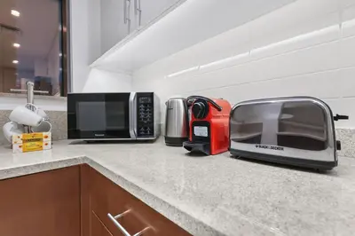 a kitchen counter with a toaster and a toaster oven at FIRST CLASS 1BR Panoramic City View in Dubai