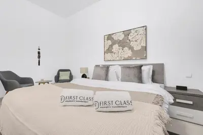 a bedroom with a bed with two first class pillows on it at FIRST CLASS 1BR Panoramic City View in Dubai