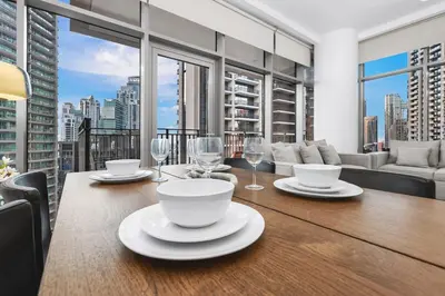 a dining room table with a view of a city at FIRST CLASS 1BR Panoramic City View in Dubai