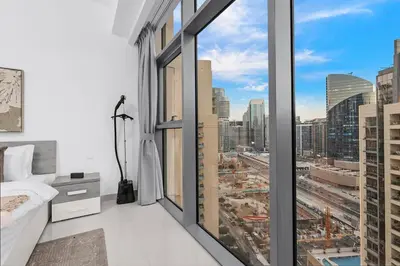 a bedroom with a large window with a city view at FIRST CLASS 1BR Panoramic City View in Dubai