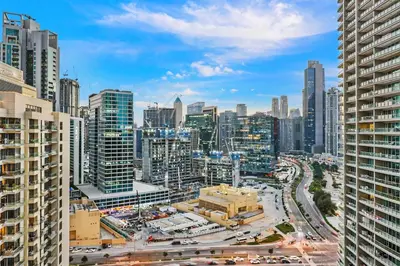 a city skyline with tall buildings and traffic at FIRST CLASS 1BR Panoramic City View in Dubai