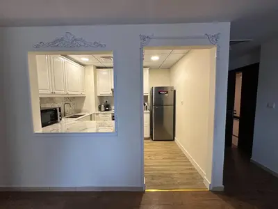 a kitchen with a refrigerator in the middle of a room at Luxe 2BR with Marina View in JBR and Walk to the Beach in Dubai