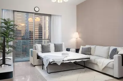 a living room with a couch and a table at FIRST CLASS 2BR Incredible Burj Khalifa View in Dubai