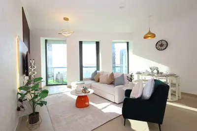 a living room with a couch and a table at Lux 2 Bed in Downtown Dubai w Dubai Mall Access in Dubai
