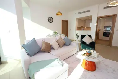 a living room with a white couch and a table at Lux 2 Bed in Downtown Dubai w Dubai Mall Access in Dubai