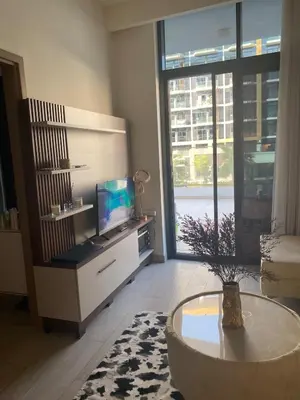 a living room with a tv and a coffee table at furnished one bedroom huge terrace in Dubai