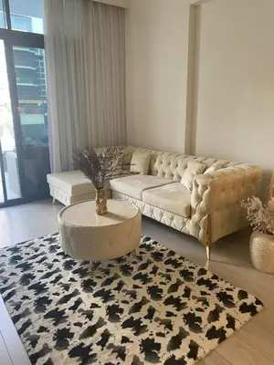 a living room with a couch and a table at furnished one bedroom huge terrace in Dubai