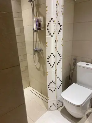 a bathroom with a shower with a toilet and a shower at furnished one bedroom huge terrace in Dubai