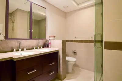 a bathroom with a sink and a toilet and a shower at Luxury Escapes - Modern 3BR Apt Stylish, Spacious and Comfortable in Dubai