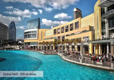 a shopping mall with a large pool of blue water at Luxury Escapes - Modern 3BR Apt Stylish, Spacious and Comfortable in Dubai