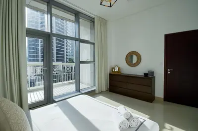 a bedroom with a bed and a large window at Luxury Escapes - Modern 3BR Apt Stylish, Spacious and Comfortable in Dubai