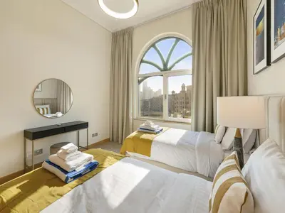 a hotel room with two beds and a window at Short-stay at Al Haseer - 4 Beds Palm Holiday Apt in Dubai