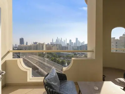 a room with a view of a city from a window at Short-stay at Al Haseer - 4 Beds Palm Holiday Apt in Dubai