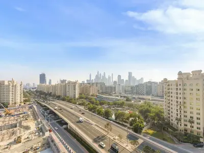 a view of a city with a highway and buildings at Short-stay at Al Haseer - 4 Beds Palm Holiday Apt in Dubai