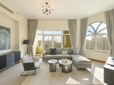 a living room with a couch and two chairs at Short-stay at Al Haseer - 4 Beds Palm Holiday Apt in Dubai