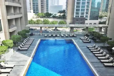 a view of a swimming pool in a building with lounge chairs at BLVD Central 2 - Studio Apartment in Downtown in Dubai