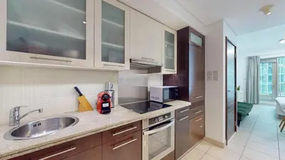 a kitchen with a sink and a stove top oven at BLVD Central 2 - Studio Apartment in Downtown in Dubai