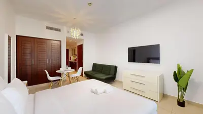 a bedroom with a bed and a living room at BLVD Central 2 - Studio Apartment in Downtown in Dubai