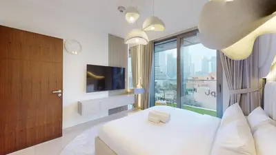 a hotel room with a bed and a television at Boulevard Point - One Bed with Burj Khalifa View in Dubai