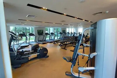 a gym with several treadmills and cardio machines at Boulevard Point - One Bed with Burj Khalifa View in Dubai