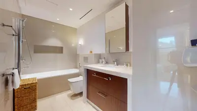 a bathroom with a sink and a toilet and a shower at Boulevard Point - One Bed with Burj Khalifa View in Dubai