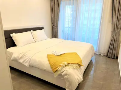 a bedroom with a bed with a yellow blanket on it at Dubai Marina - 1BHK Fancy Apartment in Dubai