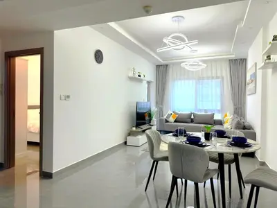 a living room with a table and a couch at Dubai Marina - 1BHK Fancy Apartment in Dubai