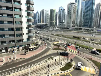 a highway in a city with cars and buildings at Dubai Marina - 1BHK Fancy Apartment in Dubai