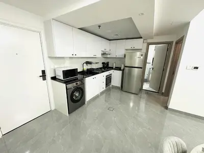 a kitchen with a refrigerator and a dishwasher at Dubai Marina - 1BHK Fancy Apartment in Dubai