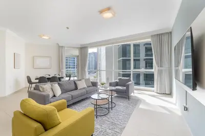 a living room with a couch and chairs at Lavish 3BR Apartment with Pool Access in Al Bateen in Dubai