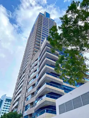 a tall building with a tree in front of it at One BedRoom near Beach and Metro in Dubai Marina Z1011 in Dubai