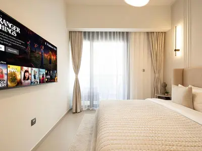 a bedroom with a large bed and a large window at Act Tower Suites by Prestige Nest in Dubai