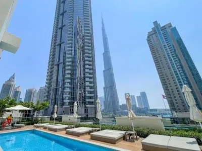 a pool in the middle of a city with tall buildings at Act Tower Suites by Prestige Nest in Dubai