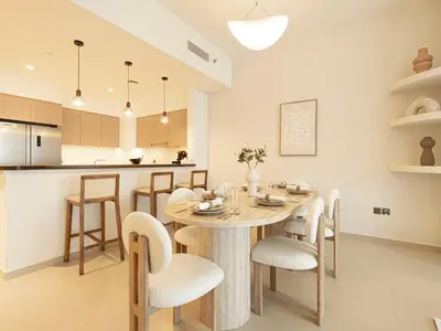 a kitchen and dining room with a table and chairs at Act Tower Suites by Prestige Nest in Dubai