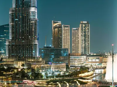 a city skyline with tall skyscrapers at night at Act Tower Suites by Prestige Nest in Dubai