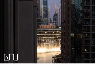 a view of a water fountain in the middle of a city at Kinfolk Homes - No 1 Family Stay, Partial Burj Khalifa Fountain View in Dubai